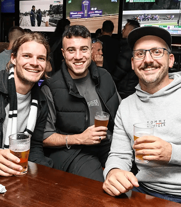 Three men smiling
